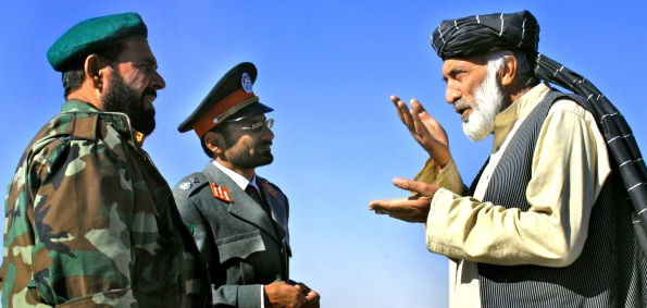 KANDAHAR, AFGHANISTAN - A local elder talks with representatives from the Afghan National Army and National Police. (US Navy Photo/David M. Votroubek)