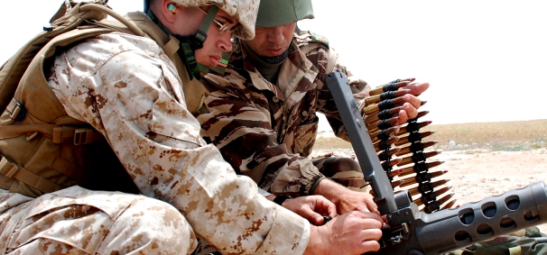 US Marine Corps Sgt. Thomas A. Beltran (left) along with a Moroccan soldier, load ammunition prior to a live fire practice in Tifnit, Morocco. (US Marine Corps photo/Master Sgt. Grady T. Fontana)