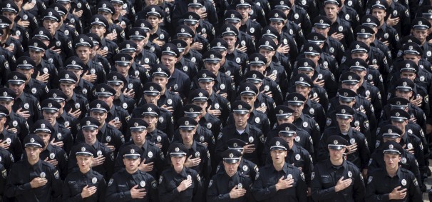 Police officers sing the national anthem during an oath-taking ceremony, which started up the work of a new police patrol service, in Kiev