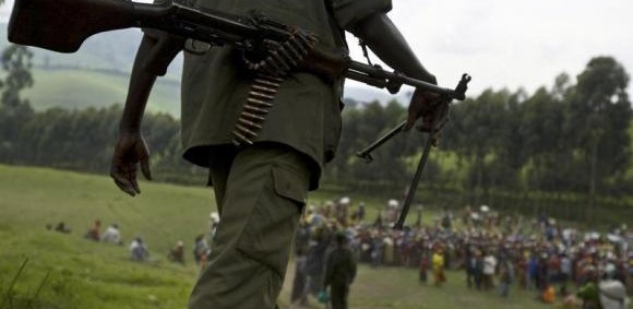 An FDLR soldier walks toward a distribution center near Lushubere Camp in Masisi in the DRC